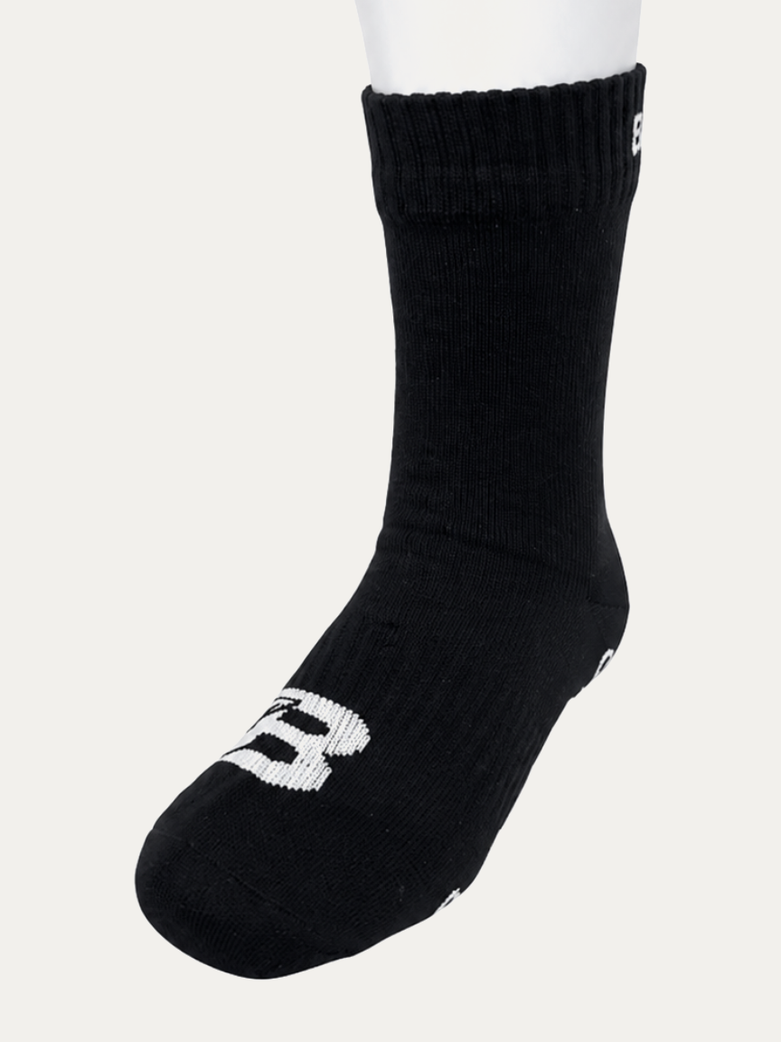 Short Bulletproof waterproof grip sock, crew height, three-quarter view showing the white B logo on the toe.